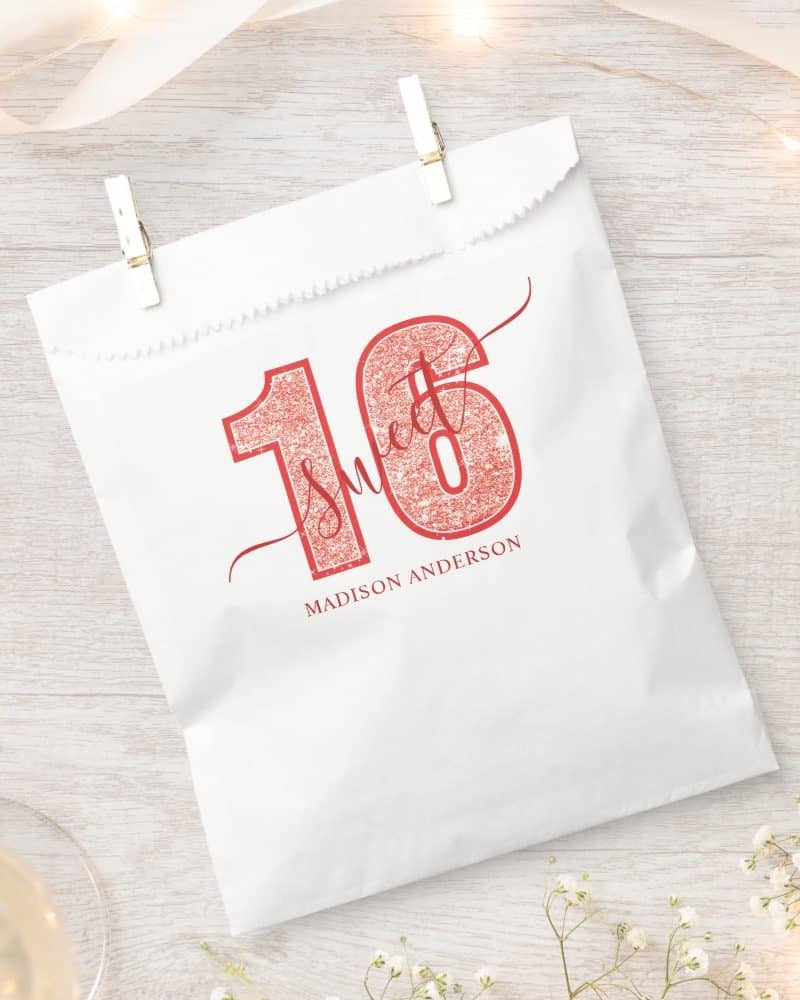 White gift bag with pink glitter Sweet 16 design and Madison Anderson's name.