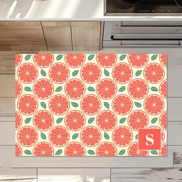 Kitchen Floor Mat With A Repeating Pattern Of Grapefruit Slices And Leaves; Monogrammed With The Letter S.