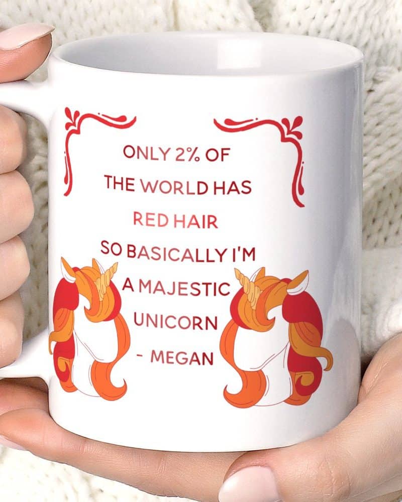 White coffee mug featuring two red-haired unicorns and text stating that only 2% of the world has red hair, making redheads majestic unicorns.