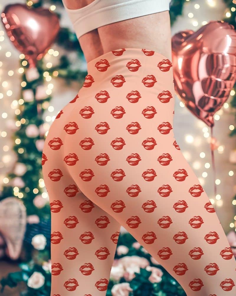 Peach-colored leggings with a repeating pattern of red lips.