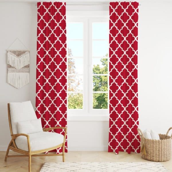 Red Curtains With A White Quatrefoil Pattern Hang In Front Of A Window.