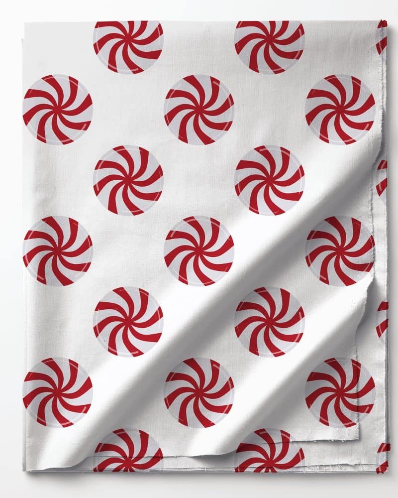 White fabric with a repeating pattern of red and white peppermint candies.