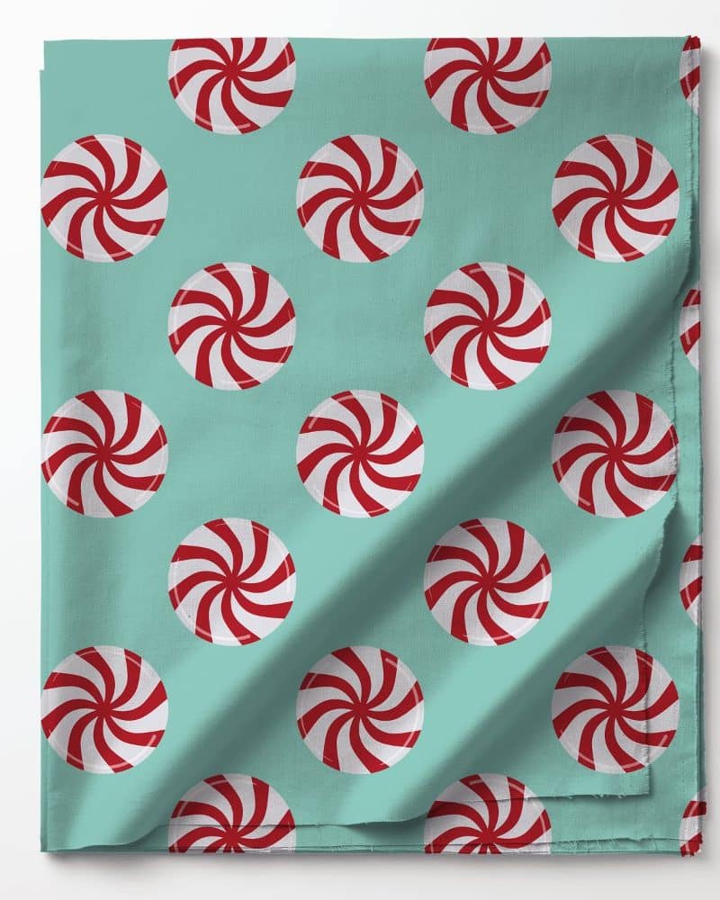 Teal fabric with a repeating pattern of red and white peppermint candies.