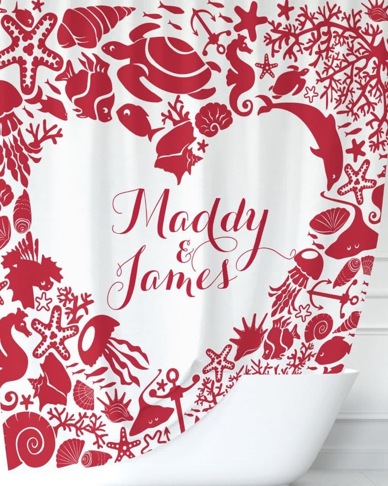 Red heart-shaped shower curtain with sea life designs and the names Maddy & James in the center.