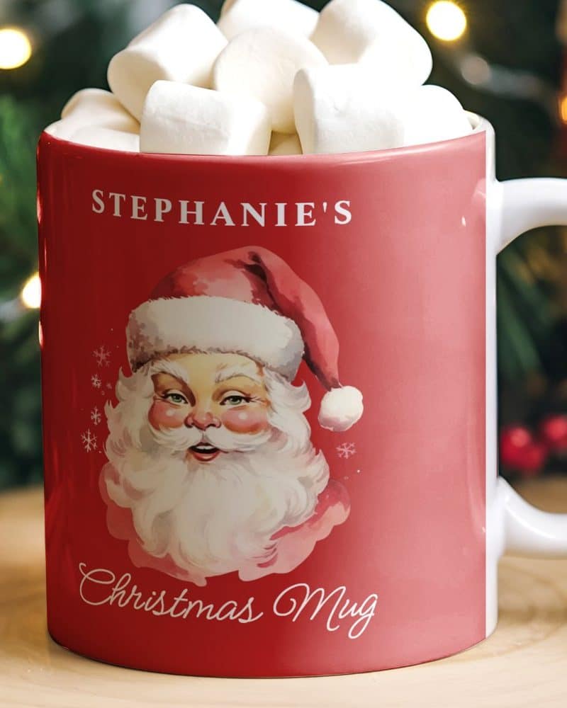 Red Christmas mug with Santa Claus image, personalized with the name Stephanie's, and filled with marshmallows.