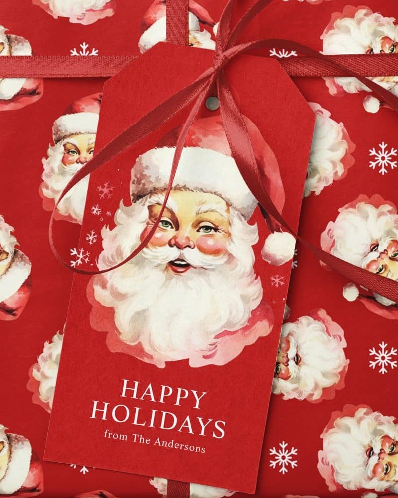A red gift tag with a watercolor Santa Claus and the message Happy Holidays from The Andersons.