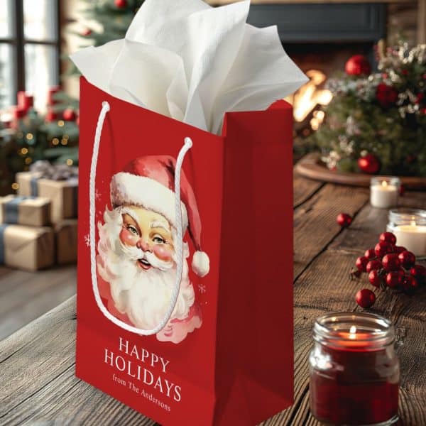 Red Gift Bag With A Vintage Santa Claus Illustration And Happy Holidays Text.