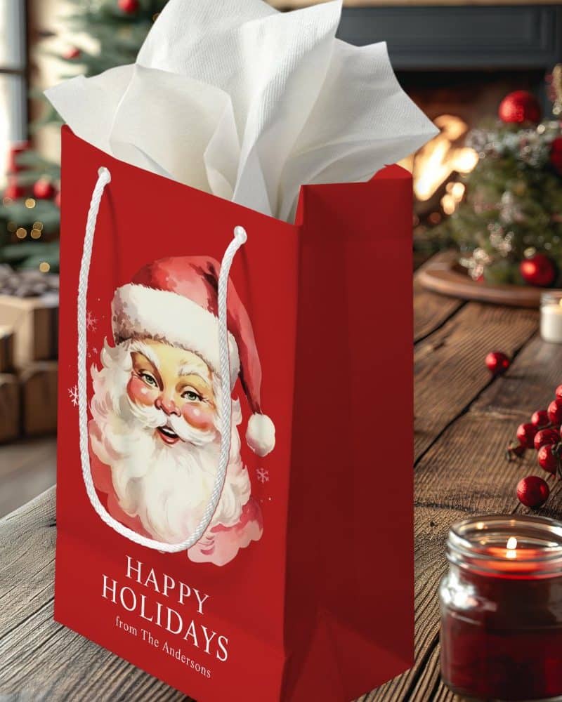 Red gift bag with a vintage Santa Claus illustration and Happy Holidays text.