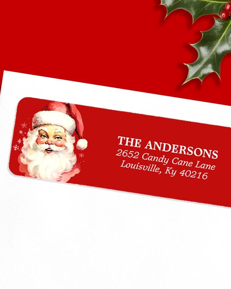 Red Christmas return address label with a vintage Santa Claus illustration and the Andersons family address.