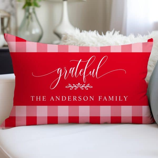 Red And Pink Gingham Pillow With The Word Grateful In A Script Font And The Text The Anderson Family.