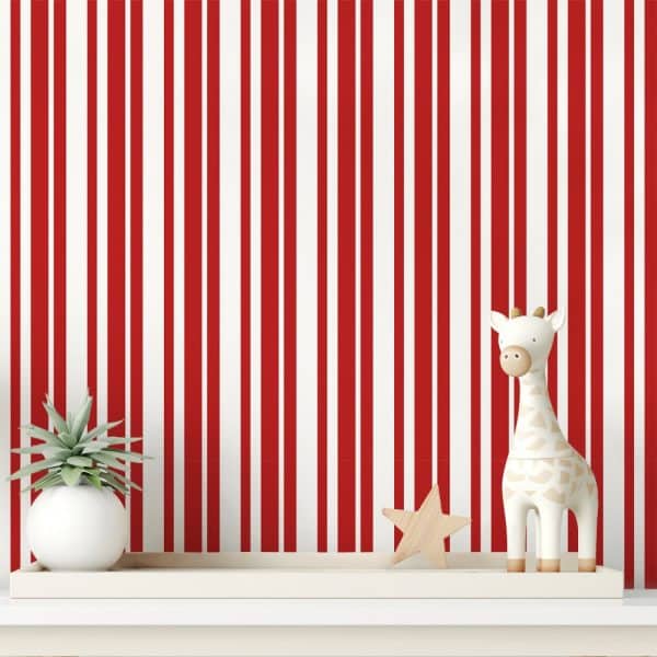 A White Shelf Holds A Small Giraffe Toy And A Small Plant Against A Red And White Striped Wall.