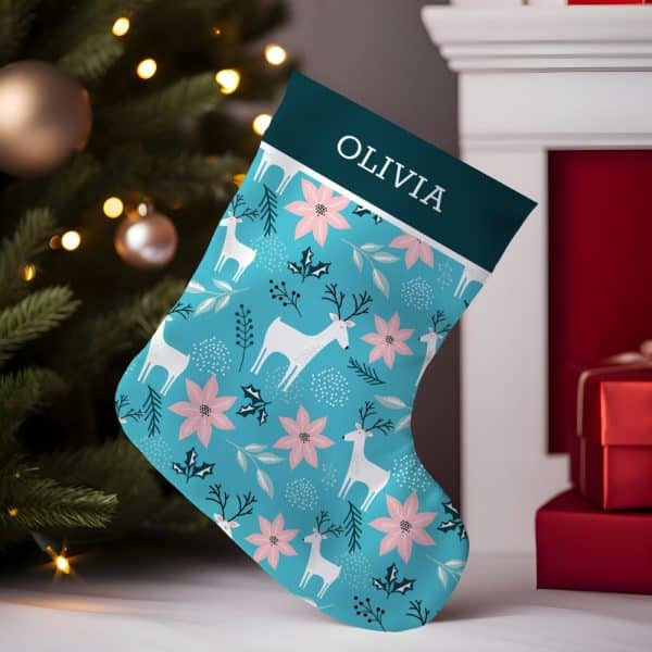 Personalized Christmas Stocking With Teal Background, White Reindeer, And Pink Poinsettias. The Name Olivia Is At The Top.