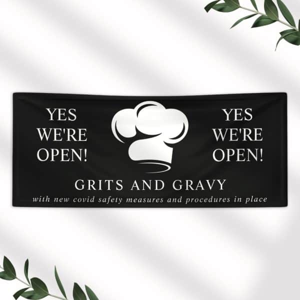 Black Banner Announcing Grits And Gravy Restaurant Is Open, With A Chef'S Hat Graphic.