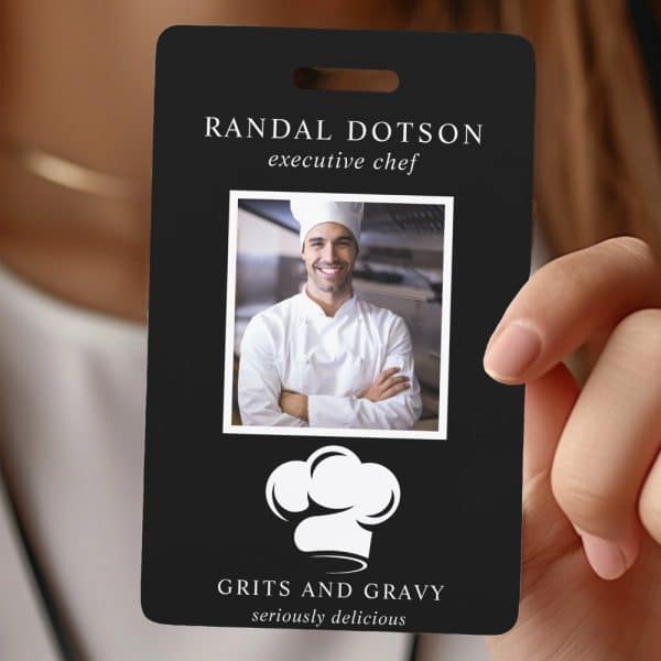 Black Employee Id Card With A Photo Of Randal Dotson, Executive Chef, A Chef'S Hat Logo, And Grits And Gravy Restaurant Name.