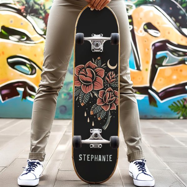 Person Holding A Black Skateboard With A Floral Design And Their Name, Stephanie, On It.