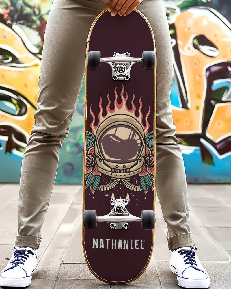 Person holding a skateboard with an astronaut helmet graphic.