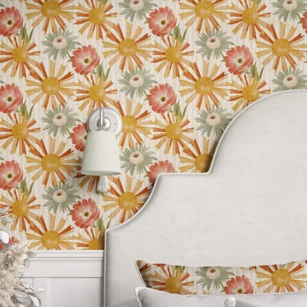 Wall With Repeating Pattern Of Stylized Sunbursts And Flowers In Muted Orange, Yellow, And Green.