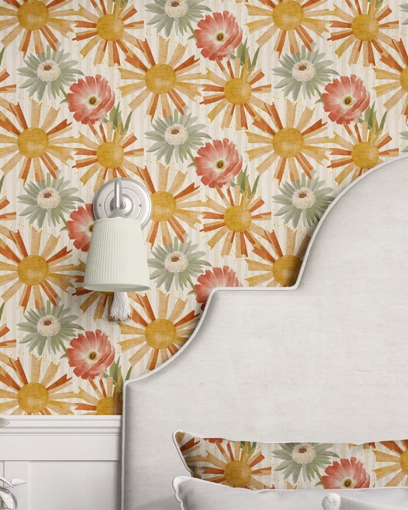 Wall with repeating pattern of stylized sunbursts and flowers in muted orange, yellow, and green.