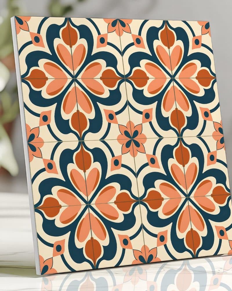 A square tile with a repeating pattern of stylized coral and rust-colored flowers on a navy blue and cream background.