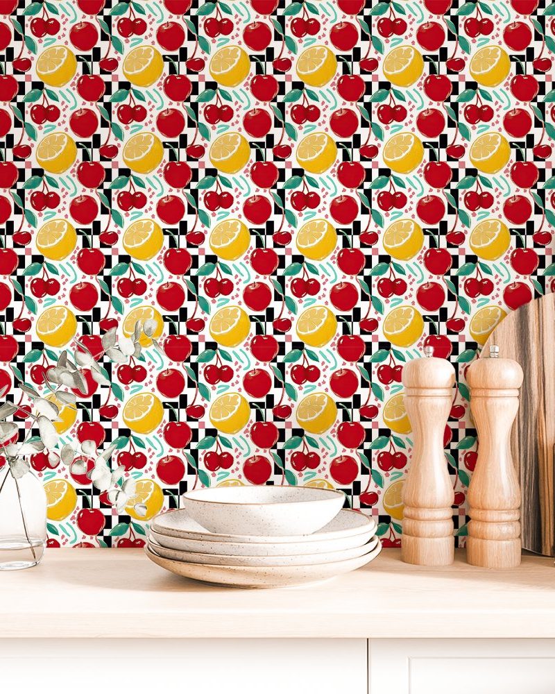 Kitchen countertop with a checkerboard pattern wallpaper featuring cherries and lemon slices.