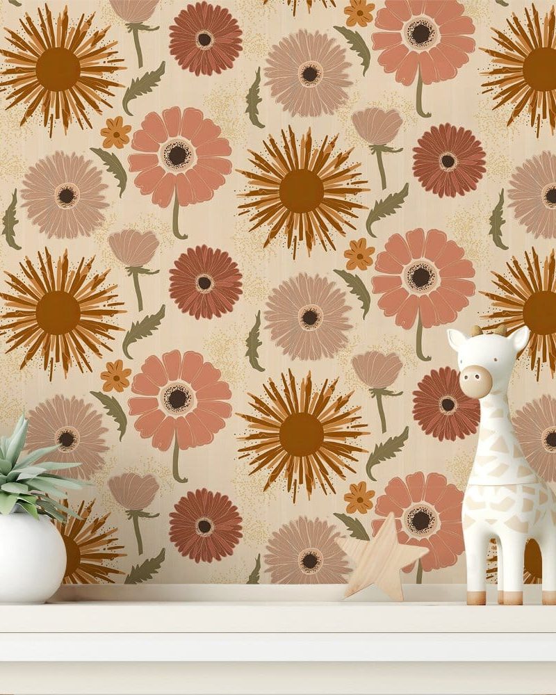 Beige wall with a repeating pattern of stylized orange, peach, and mauve flowers, a small potted plant, and a white giraffe toy on a shelf.