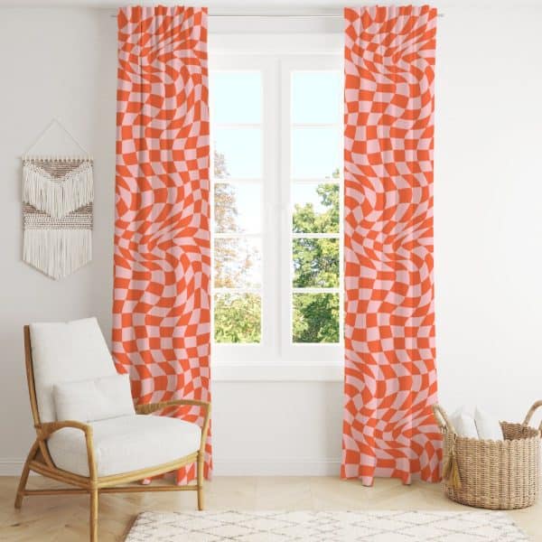 A Pair Of Orange And Pink Wavy Checkered Curtains Hang In Front Of A Window.