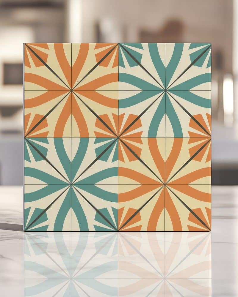 Square tile with a repeating geometric pattern in teal, orange, and beige.