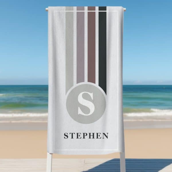 Personalized Beach Towel With Vertical Stripes And The Letter S In A Circle, Along With The Name Stephen.