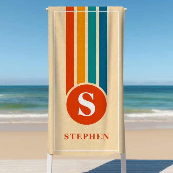 Beige Beach Towel With Retro Vertical Stripes And A Red Circle Containing The Letter S, With The Name Stephen Below.