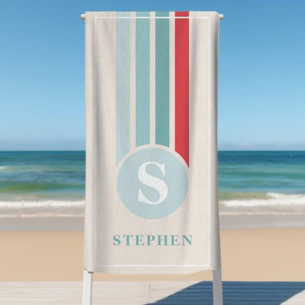 Personalized Beach Towel With Vertical Stripes, A Circle Containing The Letter S, And The Name Stephen Below.