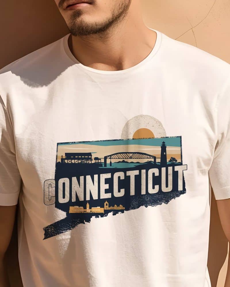 Person wearing a white t-shirt featuring a graphic design of the state of Connecticut, depicted with an outline of the state shape, and landmarks including a bridge and lighthouse.