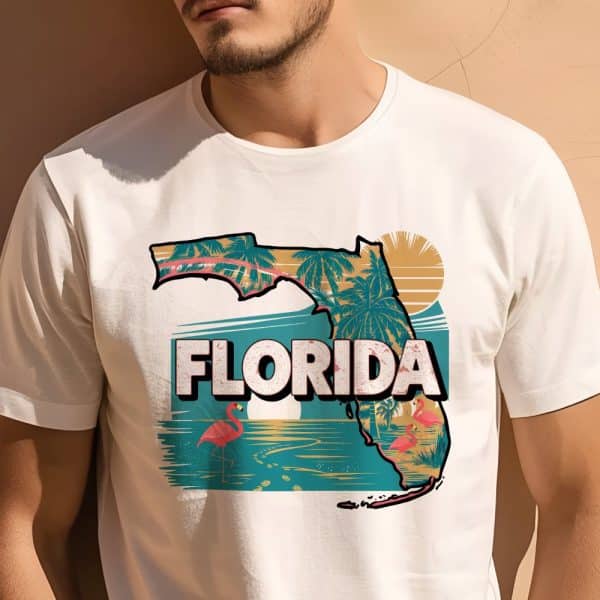 White T-Shirt Featuring A Graphic Design Of Florida'S Outline, Palm Trees, Flamingos, And A Beach Scene.