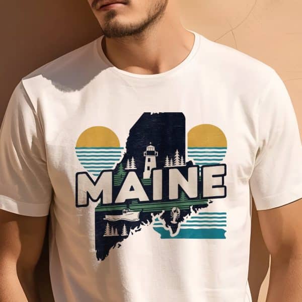 White T-Shirt Featuring A Graphic Design Of The State Of Maine, Incorporating A Lighthouse, Lobster, Boat, And Stylized Sun And Waves.