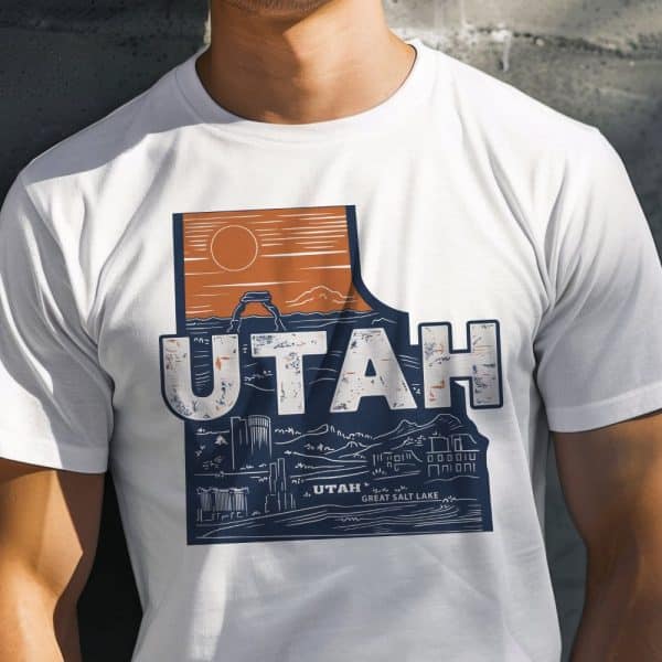 White T-Shirt Featuring A Distressed Graphic Of The Utah State Outline Incorporating Iconic Landmarks And The Word Utah.