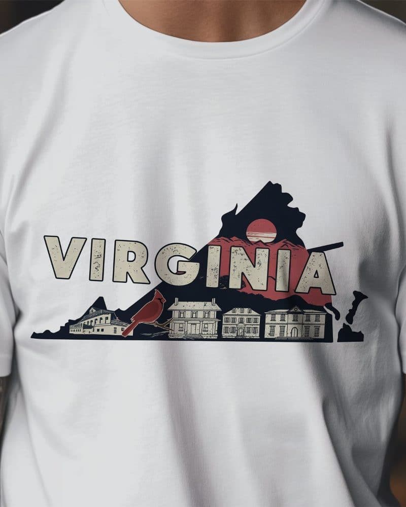 White t-shirt with a graphic design of the state of Virginia, featuring a cardinal, buildings, and a setting sun.