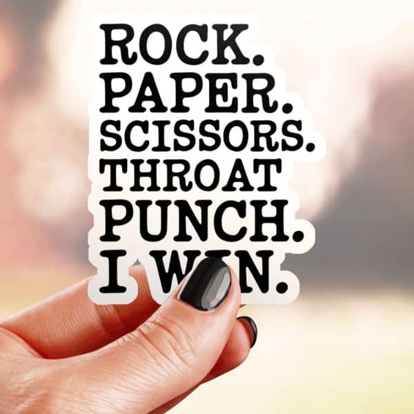 A Hand Holds A Sticker That Says Rock. Paper. Scissors. Throat Punch. I Win.
