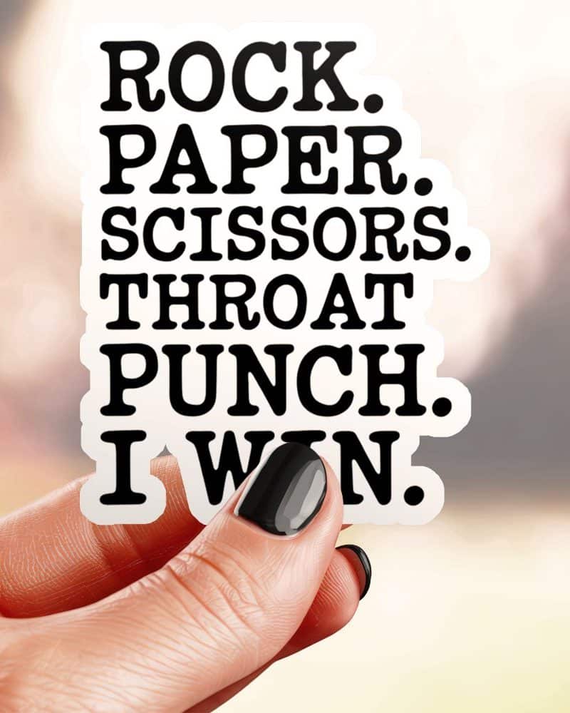 A hand holds a sticker that says Rock. Paper. Scissors. Throat Punch. I Win.