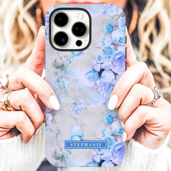 Womans Hands Holding A Phone Case With A Watercolor Floral Design Featuring Light Blue Roses And The Name Stephanie.