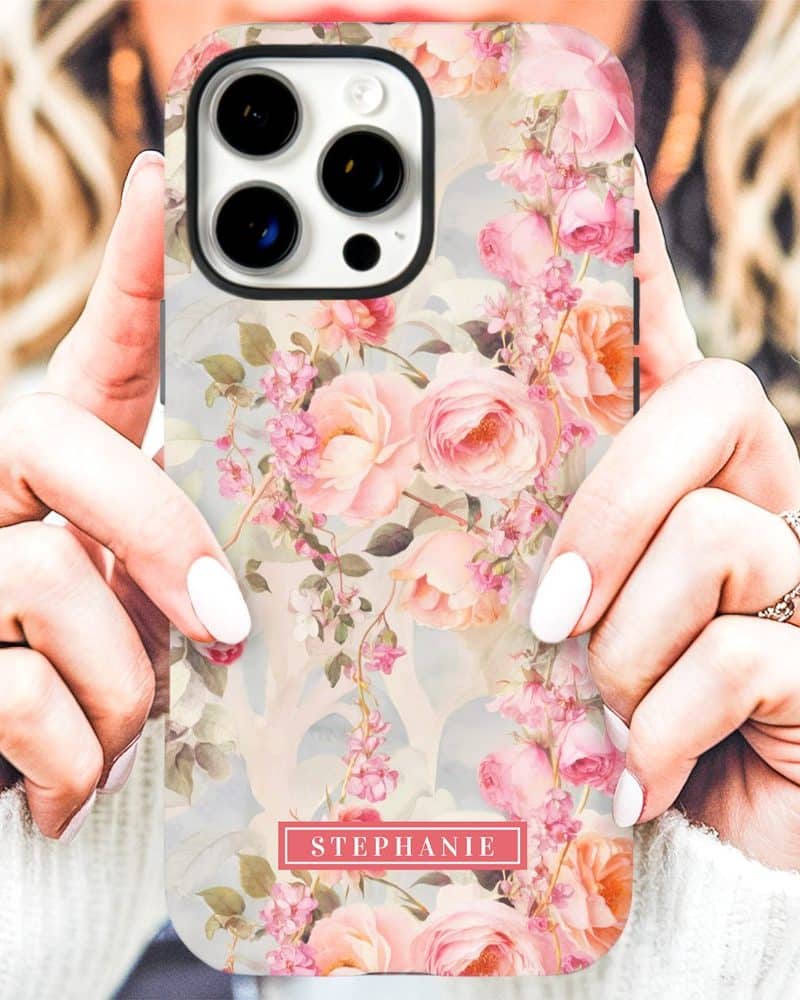 A woman's hands holding a phone case with a floral design and the name Stephanie.