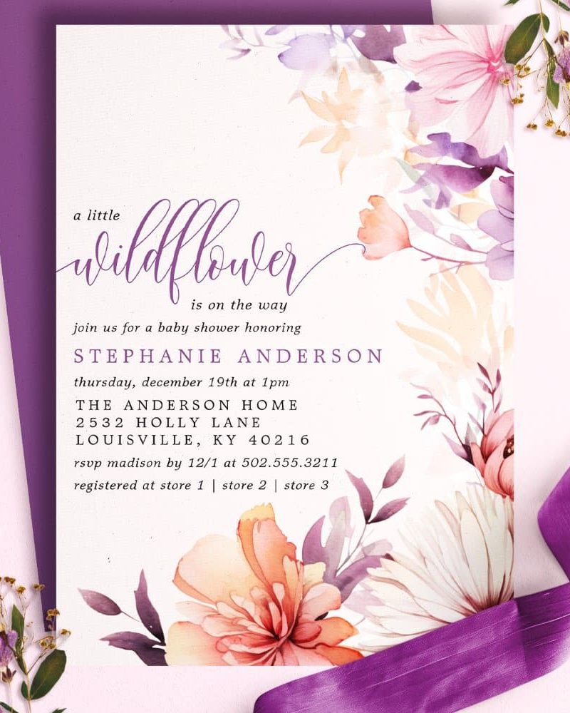 Baby shower invitation with watercolor wildflowers in shades of purple, orange, and pink.