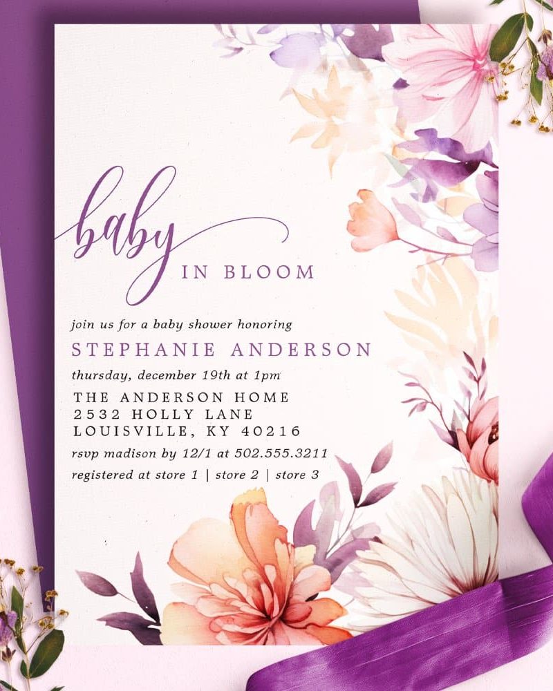 Baby shower invitation with watercolor flowers in shades of purple, pink, and orange.
