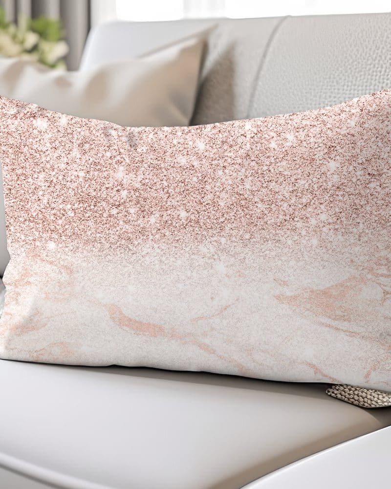 Rose gold glitter ombre throw pillow on a white couch.