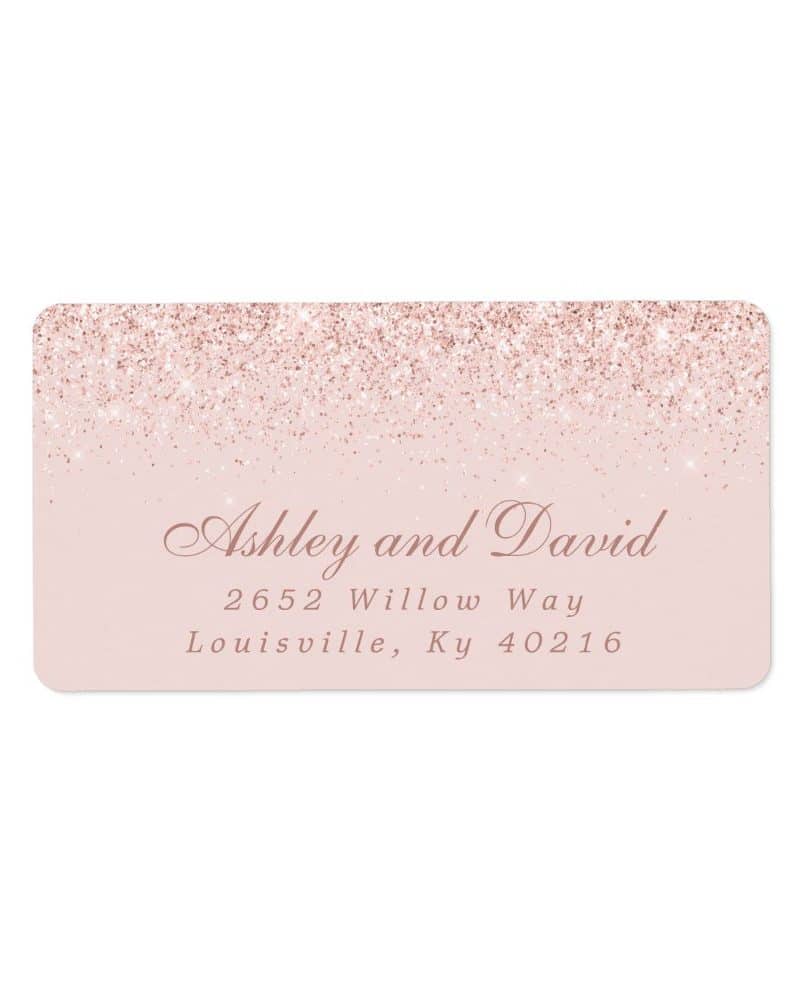 Pink glitter-topped return address label with Ashley and David's address.