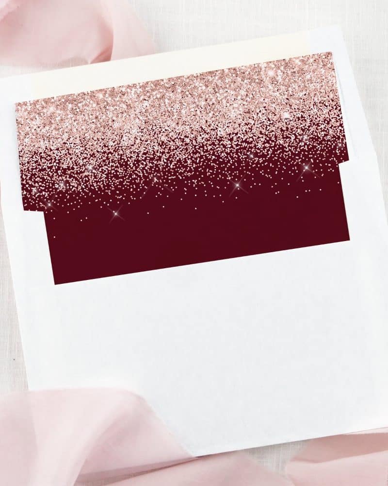 White envelope liner with a burgundy and rose gold glitter design.
