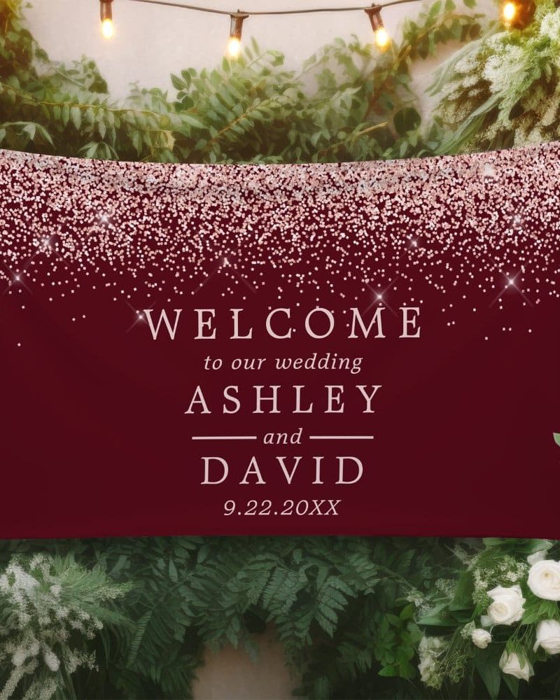 Burgundy wedding welcome sign with rose gold glitter and the names Ashley and David.
