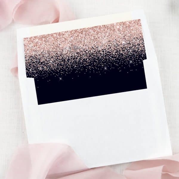 White Envelope With A Dark Navy Blue And Rose Gold Glitter Liner.