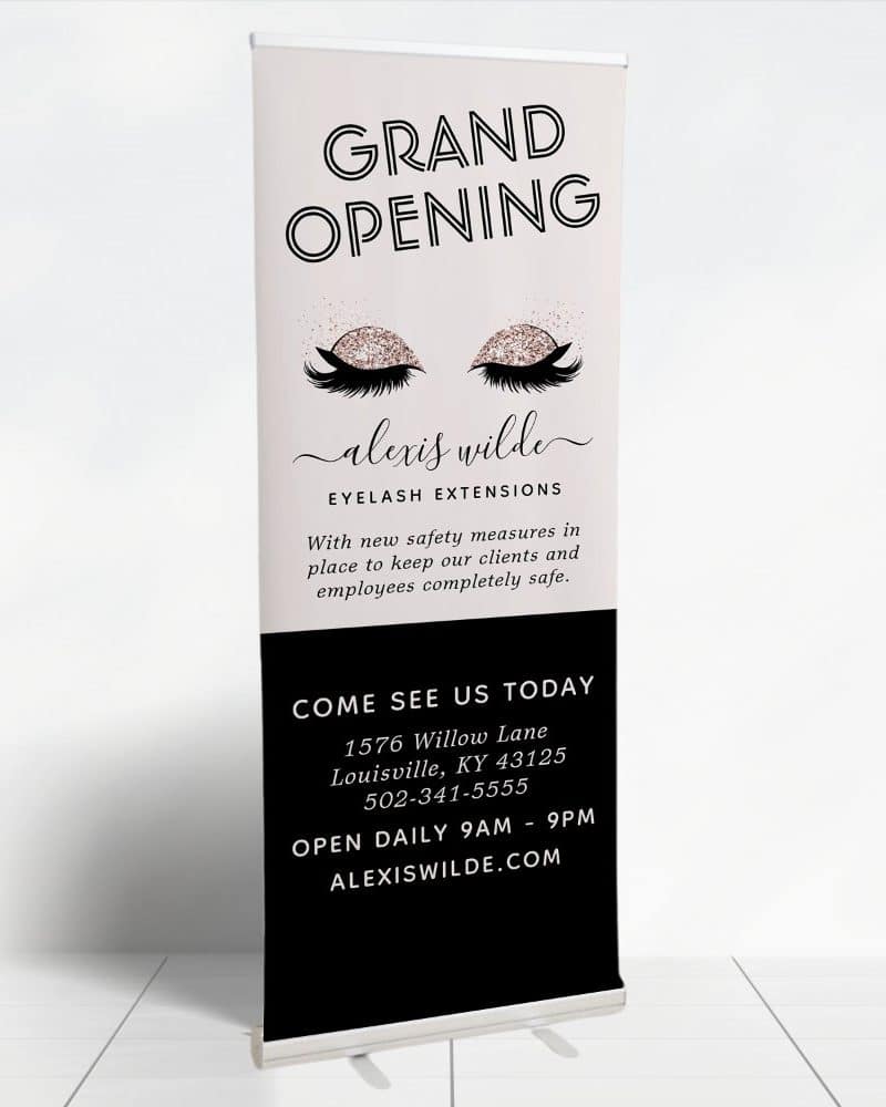 Grand opening retractable banner for Alexis Wilde Eyelash Extensions. Features stylized eyes with lashes and business information.