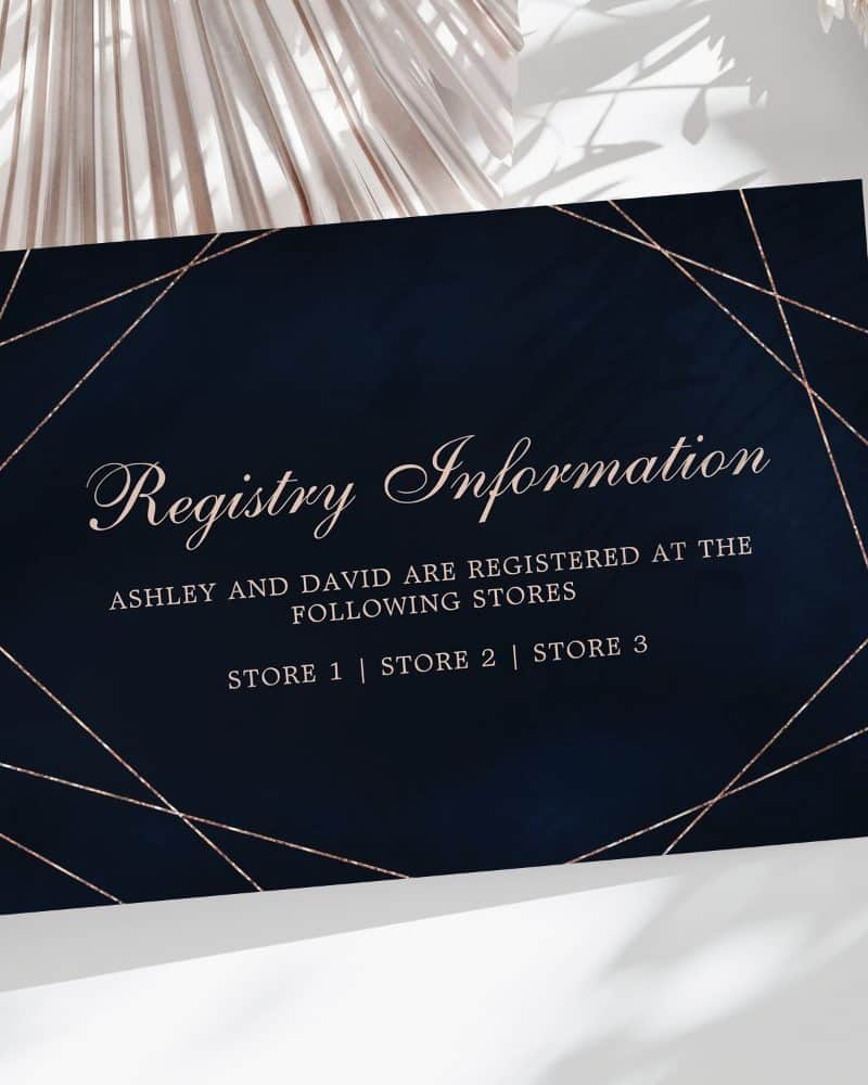 Dark blue wedding registry card with rose gold geometric lines and text listing Ashley and David's registry information.