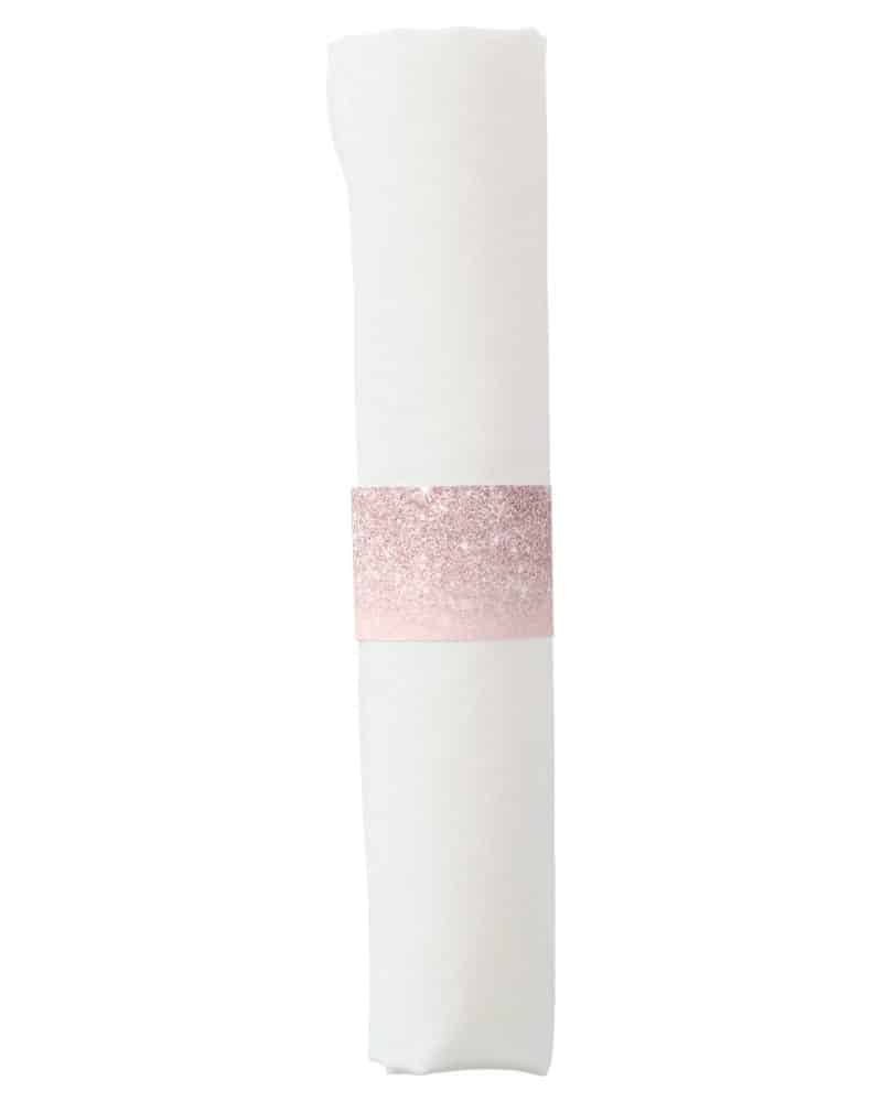 White napkin with a rose gold glitter napkin ring.