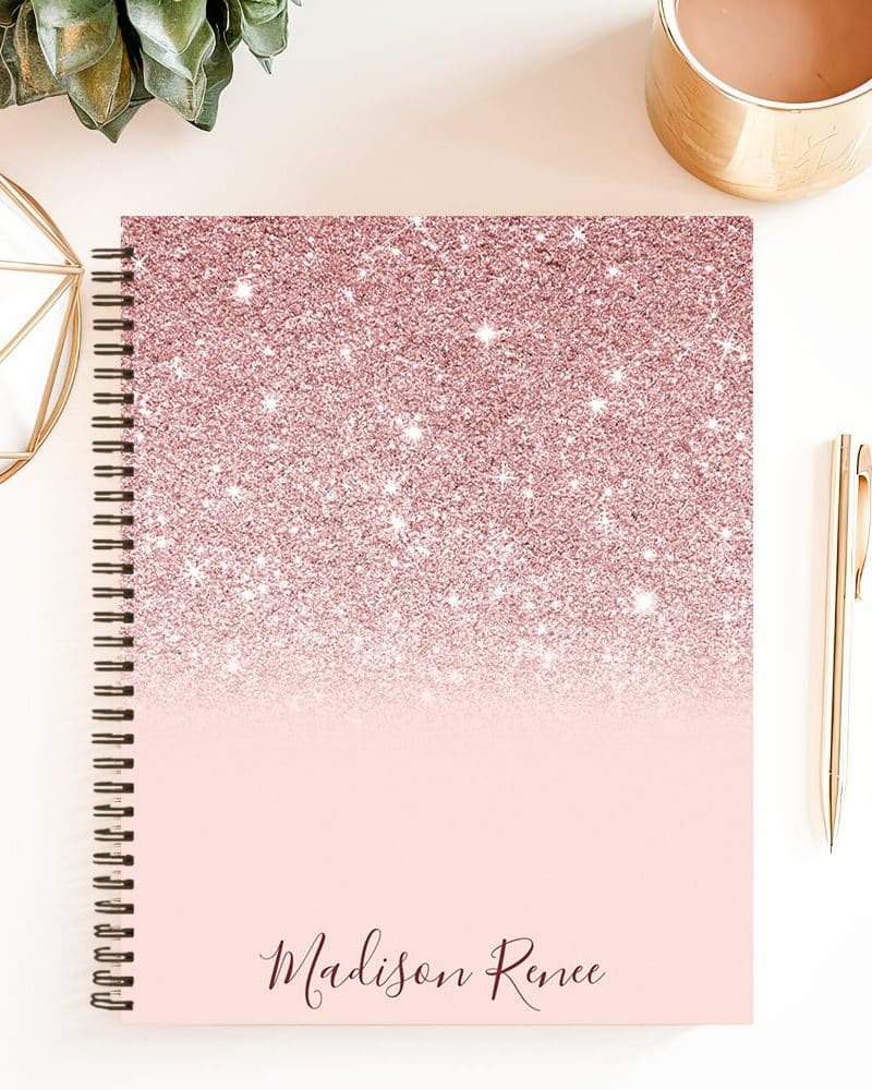 Spiral-bound notebook with a rose gold glitter ombre design and the name Madison Renee.